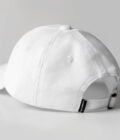 black cap with yellow blackletter embroidery and white sandwich backside view